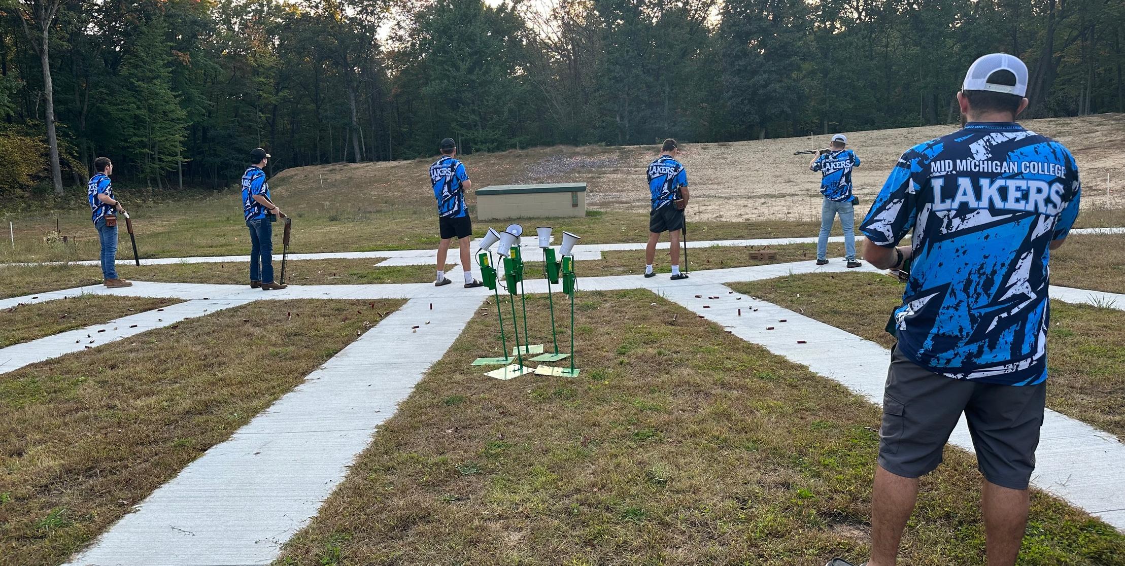 Image of Coach Magnus and Clay Target Shooting team shooting their warm up rounds outdoors
